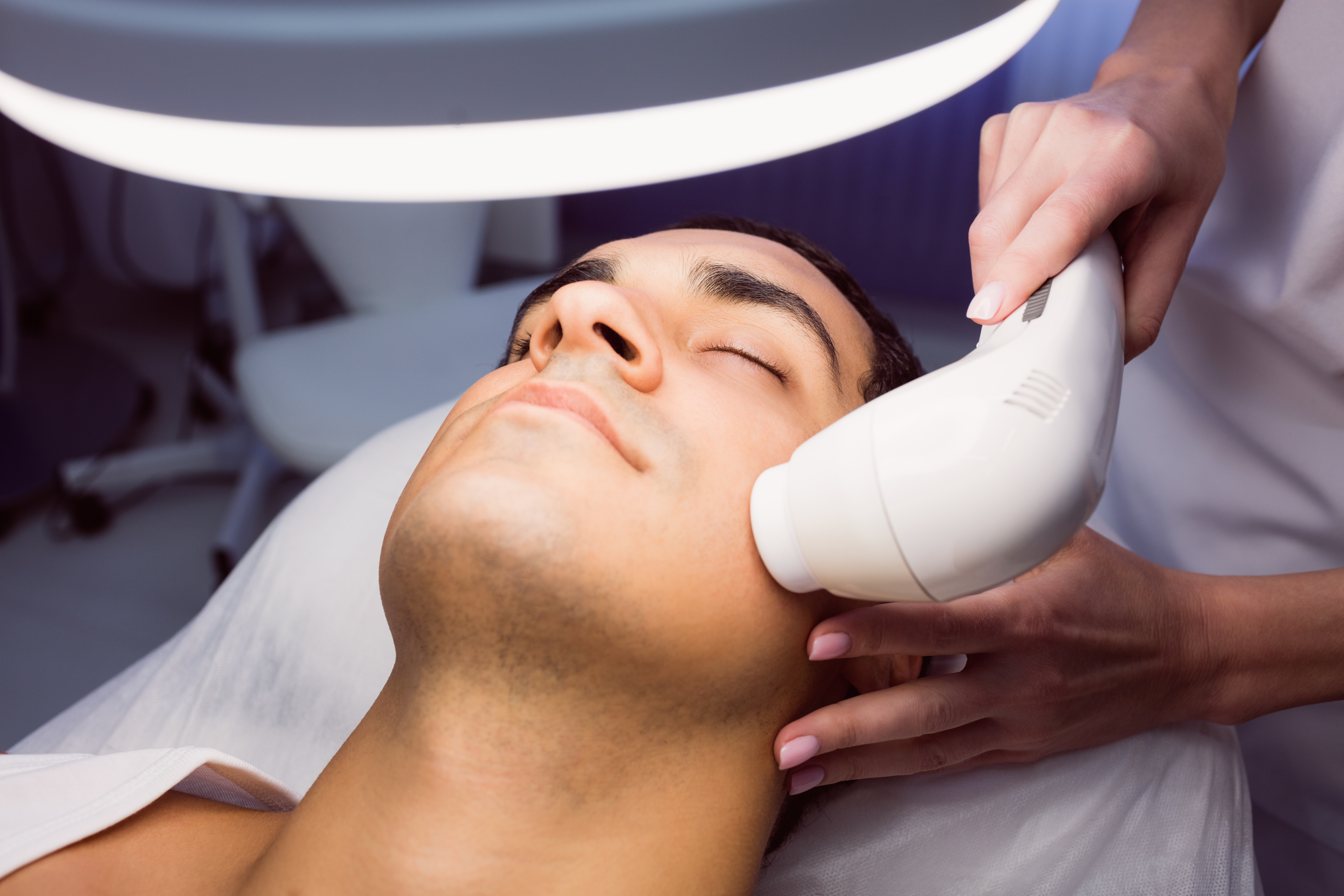 man-getting-facial-massage-clinic